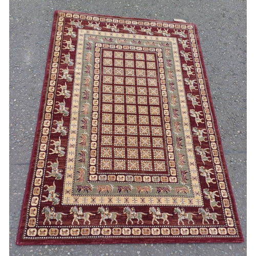 1431 - BURGUNDY GROUND FULL WOOL PILE RUG WITH  UNIQUE DESIGN WITH ANIMAL MOTIVES 196 X 130CM