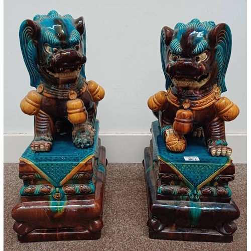 3002 - PAIR ORIENTAL DOGS OF FU ON STANDS. OVERALL HEIGHT 61 CMS