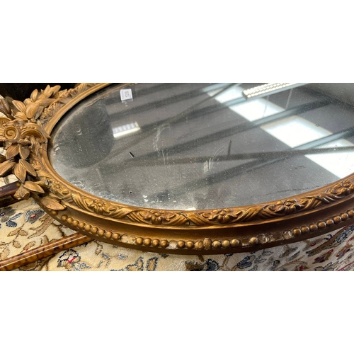 265 - 20TH CENTURY GILT FRAMED OVAL MIRROR, HEIGHT 86CM