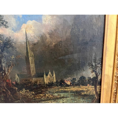 1142 - GILT FRAMED OIL ON CANVAS, 2 FIGURES BY A RIVER & CATHEDRAL, SIGNED INDISTINCTLY, 59 X 49 CM