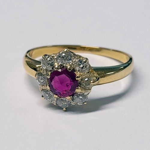 260 - RUBY & DIAMOND CLUSTER RING, THE CIRCULAR CUT RUBY SET WITHIN A SURROUND OF 8 DIAMONDS APPROX 0.6 CA... 