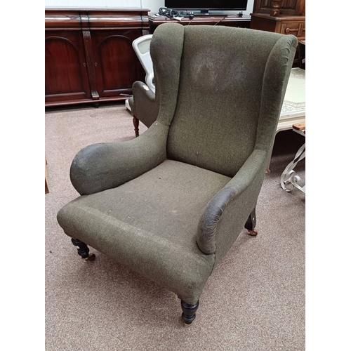 5009 - 19TH CENTURY OVERSTUFFED WINGBACK ARMCHAIR ON TURNED SUPPORTS STAMPED '2056' TO LEG