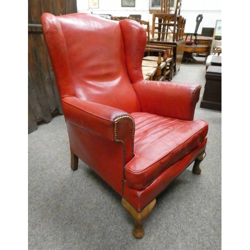 5186 - RED LEATHER WINGBACK ARMCHAIR WITH BRASS STUDWORK ON SHORT QUEEN ANNE SUPPORTS