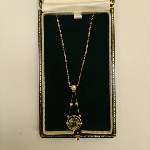 111 - EARLY 20TH CENTURY 15CT GOLD PEARL & PERIDOT NEGLIGEE PENDANT. THE CIRCULAR PERIDOT SET BETWEEN 4 SE... 