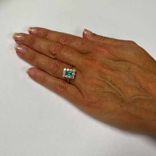 358 - GOLD EMERALD & DIAMOND CLUSTER RING, THE RECTANGULAR CUT EMERALD SET WITHIN A SURROUND OF 10 BRILLIA... 