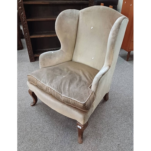 290 - OVERSTUFFED WINGBACK ARMCHAIR ON SHAPED SUPPORTS