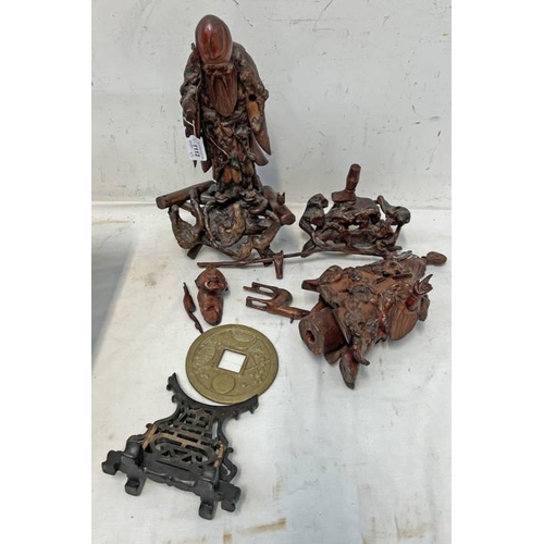 1112 - TWO CARVED WOODEN ORIENTAL FIGURES ON STANDS ALONG WTIH A CIRCULAR CAST METAL ORIENTAL PLAQUE ON STA... 