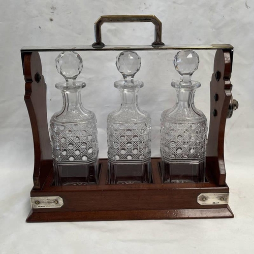 34 - MAHOGANY TANTALUS WITH SILVER MOUNTS, LONDON 1902 & 3 CUT GLASS DECANTERS