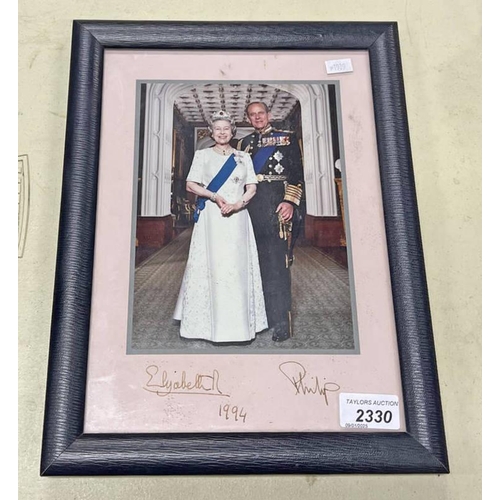 2330 - FRAMED PHOTOGRAPH OF PRINCE PHILIP AND QUEEN ELIZABETH II, SIGNED AND DATED 1994 TO THE MOUNT, IN SM... 