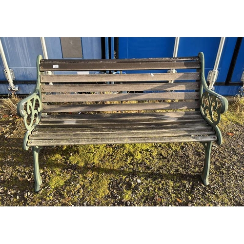 483 - WOODEN GARDEN BENCH WITH DECORATIVE CAST METAL ENDS