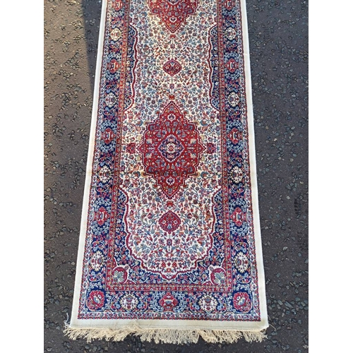 2063 - LARGE IVORY GROUND CASHMERE RUNNER WITH FULL PILE AND A TRADITIONAL MEDALLION DESIGN 502CM X 77CM