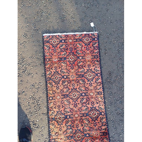 2076 - WASHED RED GROUND PERSIAN SUROK RUNNER WITH ALL OVER DESIGN 315CM X 58CM