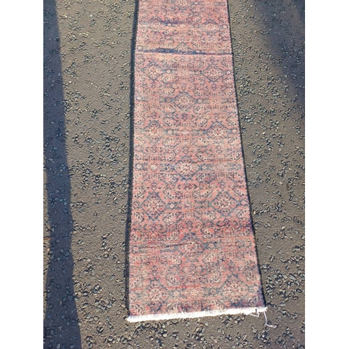 2076 - WASHED RED GROUND PERSIAN SUROK RUNNER WITH ALL OVER DESIGN 315CM X 58CM