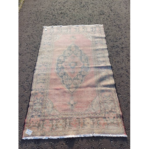 2106 - WASHED RED GROUND AND WOVEN PERSIAN VILLAGE RUG WITH CENTRAL MEDALLION DESIGN 205CM X 125CM