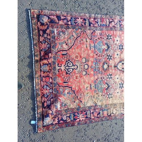 2112 - RED GROUND PERSIAN RUG WITH ALL OVER DESIGN 286 X 149CM