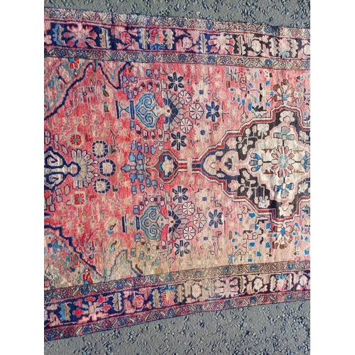 2112 - RED GROUND PERSIAN RUG WITH ALL OVER DESIGN 286 X 149CM