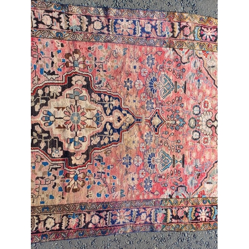 2112 - RED GROUND PERSIAN RUG WITH ALL OVER DESIGN 286 X 149CM