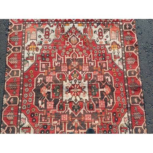 2130 - WASHED RED GROUND WOVEN PERSIAN HERIZ RUG WITH TRADITIONAL DESIGN  199CM X 159CM