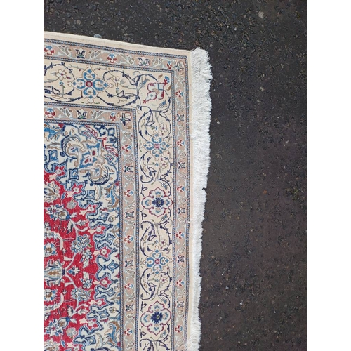 2133 - FINE HAND WOVEN PERSIAN NIAN CARPET WITH RED CENTRE WITH A IVORY SURROUND 289CM X 195CM