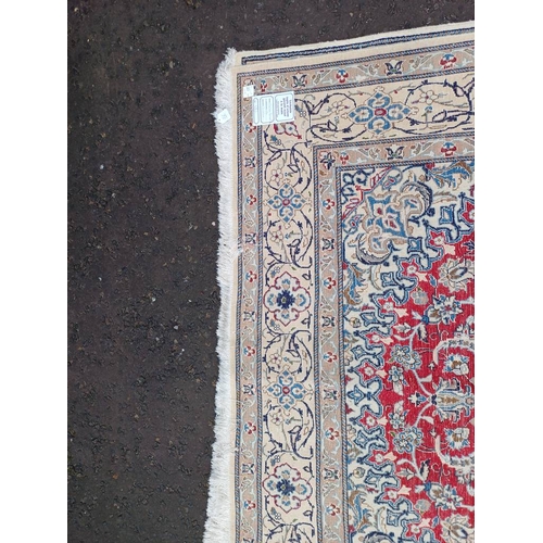 2133 - FINE HAND WOVEN PERSIAN NIAN CARPET WITH RED CENTRE WITH A IVORY SURROUND 289CM X 195CM