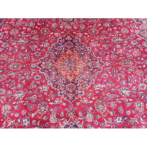 2145 - RED GROUND HAND WOVEN PERSIAN MASHED CARPET WITH FLORAL MEDALLION DESIGN 349CM X 262CM