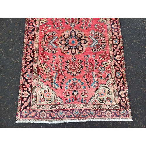 2178 - WASHED RED GROUND PERSIAN VILLAGE RUG WITH CENTRE MEDALLION DESIGN 189CM X 122CM