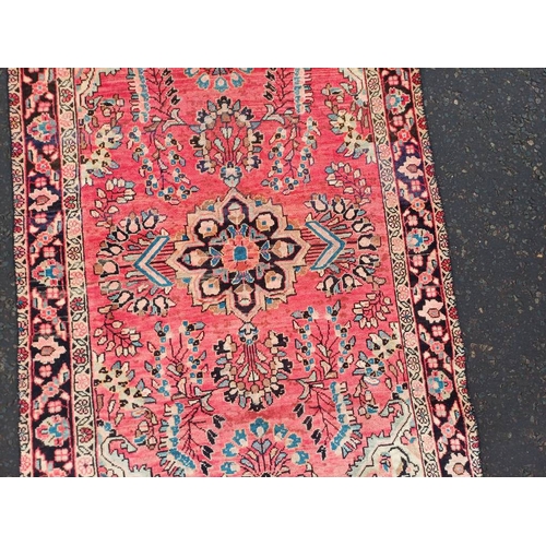 2178 - WASHED RED GROUND PERSIAN VILLAGE RUG WITH CENTRE MEDALLION DESIGN 189CM X 122CM