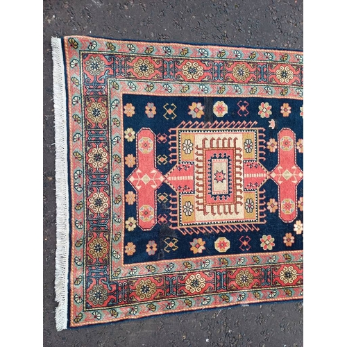 2190 - HAND WOVEN FULL PILE CAUCASIAN RUG, BLUE GROUND WITH A GEOMETRICAL MEDALLION DESIGN 201 X 120CM