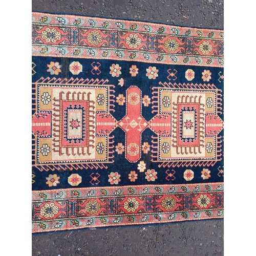 2190 - HAND WOVEN FULL PILE CAUCASIAN RUG, BLUE GROUND WITH A GEOMETRICAL MEDALLION DESIGN 201 X 120CM