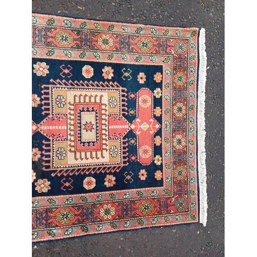 2190 - HAND WOVEN FULL PILE CAUCASIAN RUG, BLUE GROUND WITH A GEOMETRICAL MEDALLION DESIGN 201 X 120CM