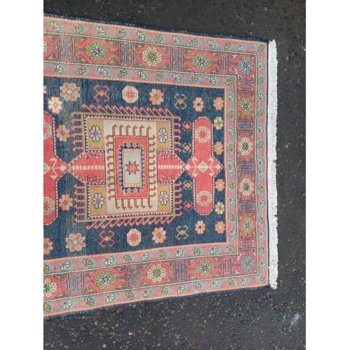 2190 - HAND WOVEN FULL PILE CAUCASIAN RUG, BLUE GROUND WITH A GEOMETRICAL MEDALLION DESIGN 201 X 120CM