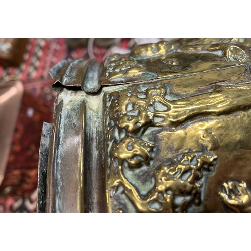 2006 - LATE 19TH OR EARLY 20TH CENTURY BRASS OVAL BIN EMBOSSED WITH CHERUBS IN FOREST SCENE, 49CM ACROSS