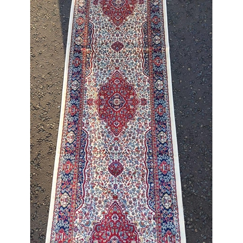 2063 - LARGE IVORY GROUND CASHMERE RUNNER WITH FULL PILE AND A TRADITIONAL MEDALLION DESIGN 502CM X 77CM