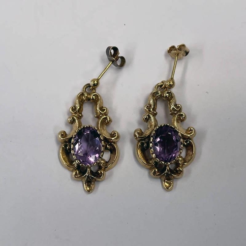 368 - PAIR 9CT GOLD AMETHYST SET EARRINGS IN DECORATIVE SCROLL SETTING 3.5 CM LONG, 8.6 G