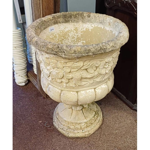 5218 - RECONSTITUTED STONE GARDEN URN WITH FLORAL DECORATION ON CIRCULAR PLINTH, 65CM TALL