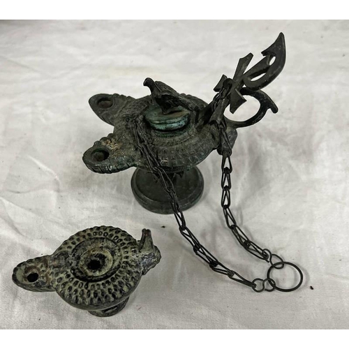 1423A - BYZANTINE STYLE BRONZE OIL LAMP WITH TWIN SPOUTS, & A CROSS HANDLE, THE LID WITH FALCON KNOP ON A CI... 