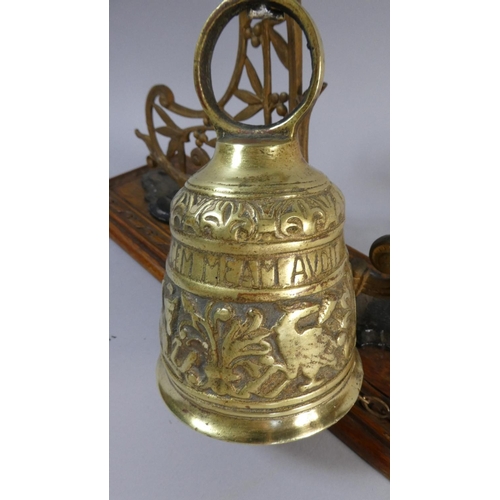 48 - A Brass Bell Supported on Unrelated Pierced Metal Stand with Carved Oak Plinth, 34cm High