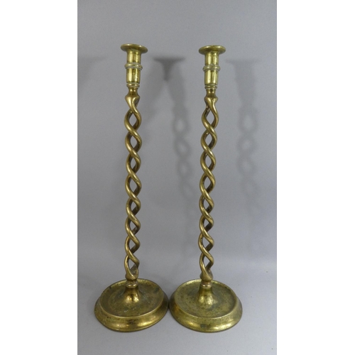 113 - A Pair of 19th Century Brass Spiral Candlesticks on Circular Bases. 53cms High