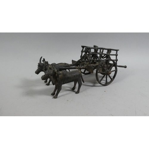 121 - A 20th Century African Benin Bronze Figural Group of Men Riding in a Cart Pulled by Two Oxen. 24cms ... 