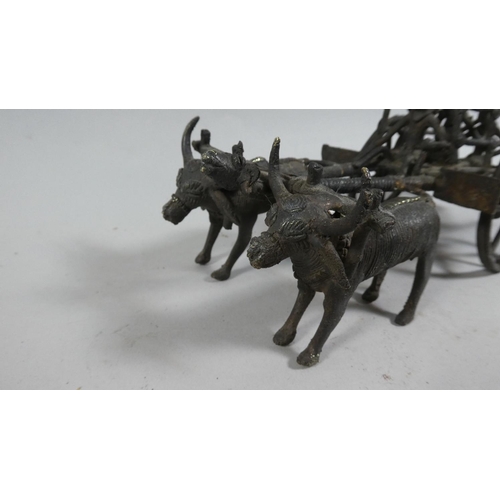 121 - A 20th Century African Benin Bronze Figural Group of Men Riding in a Cart Pulled by Two Oxen. 24cms ... 