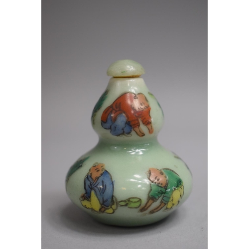 216 - A Chinese Celadon Double Gourd Snuff Bottle decorated with Applied Enamels depicting Farmers Toiling... 