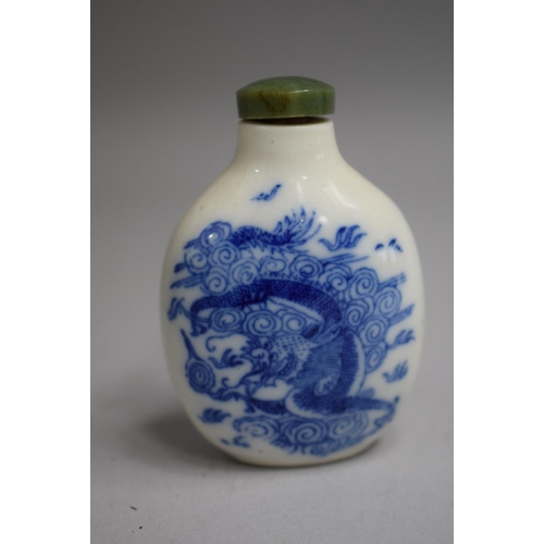 218 - A Chinese Blue and White Glazed Snuff Bottle of Bulbous Pear Shaped Form decorated with Dragon Among... 