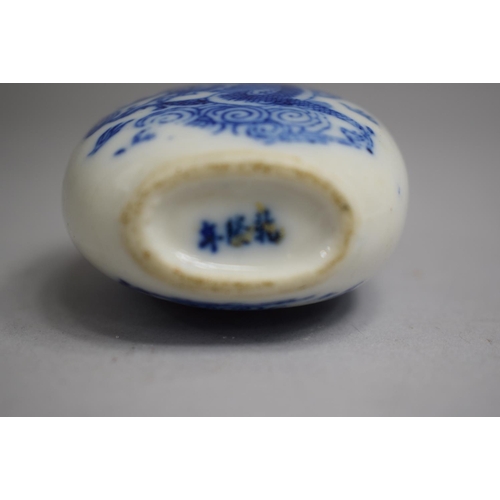 218 - A Chinese Blue and White Glazed Snuff Bottle of Bulbous Pear Shaped Form decorated with Dragon Among... 