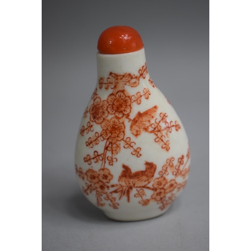 220 - A Chinese Ceramic Snuff Bottle of Pear Shape decorated with Orange Enamels depicting Birds in Foliag... 