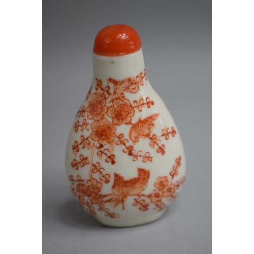 220 - A Chinese Ceramic Snuff Bottle of Pear Shape decorated with Orange Enamels depicting Birds in Foliag... 