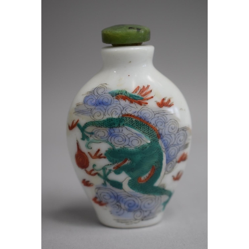 221 - A Chinese Ceramic Snuff Bottle of Flattened Spade Form decorated with Famille Vert Colouration depic... 