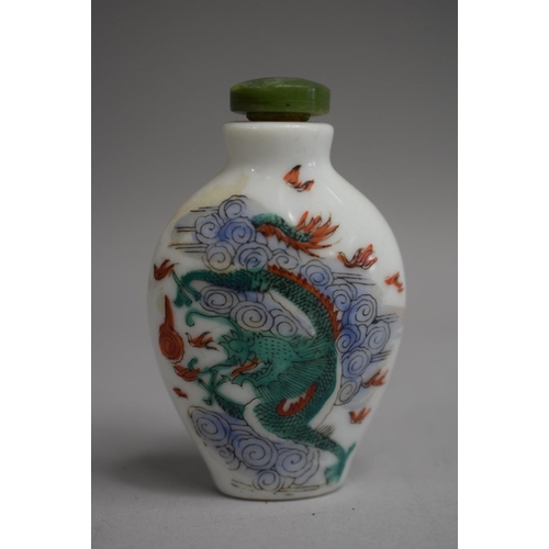 221 - A Chinese Ceramic Snuff Bottle of Flattened Spade Form decorated with Famille Vert Colouration depic... 