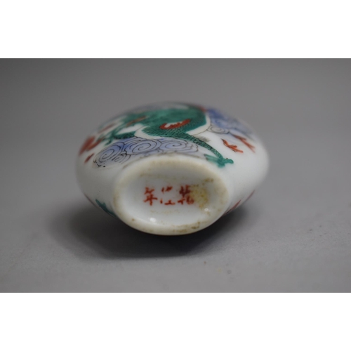 221 - A Chinese Ceramic Snuff Bottle of Flattened Spade Form decorated with Famille Vert Colouration depic... 