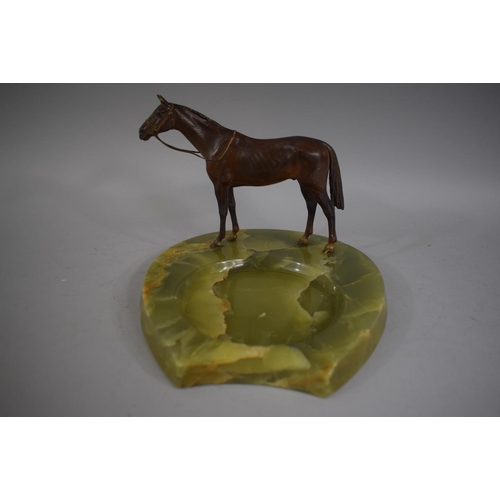 258 - A Cold Painted Bronze Study of a Race Horse on Green Onyx Ashtray Base in the form of a Horseshoe