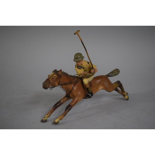 259 - A Cold Painted Bronze Figure of a Mounted Polo Player. 12cms Long